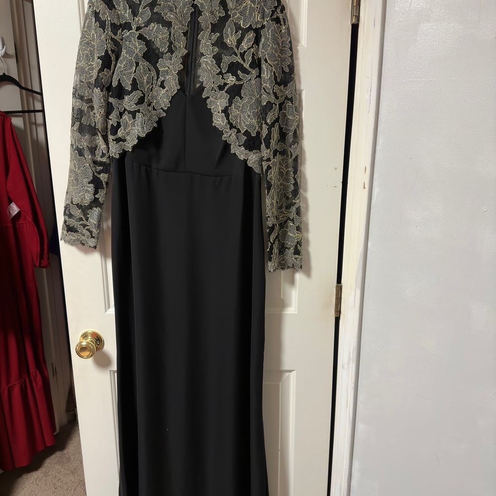 Long sleeve maxi dress has a small train.